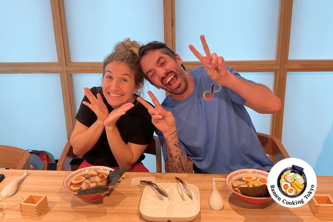 Couple posing with peace signs during their fun cooking session