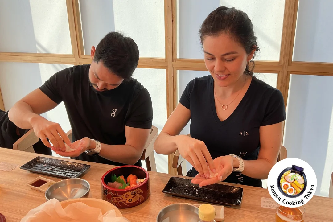 Couple making nigiri sushi together