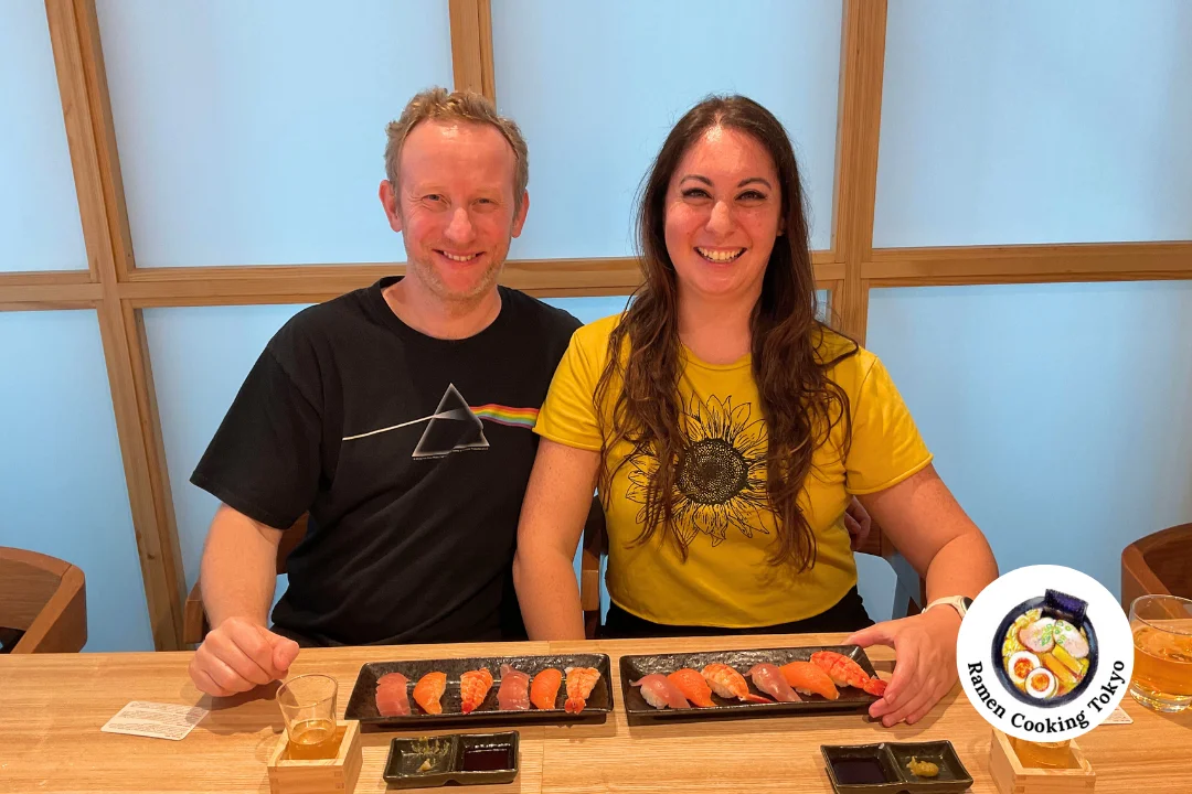 Smiling couple with their completed ramen and sushi