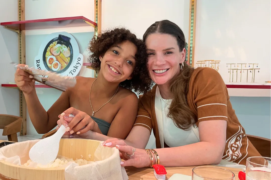 Mother and daughter learning to make sushi together