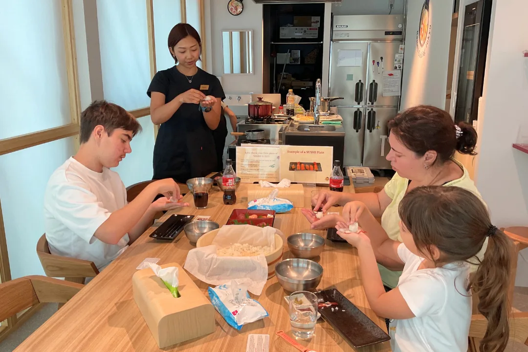 Family sushi lesson with instructor guidance