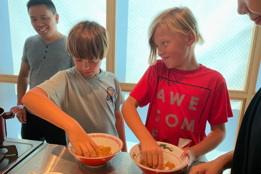 Kids mixing ramen toppings and seasonings