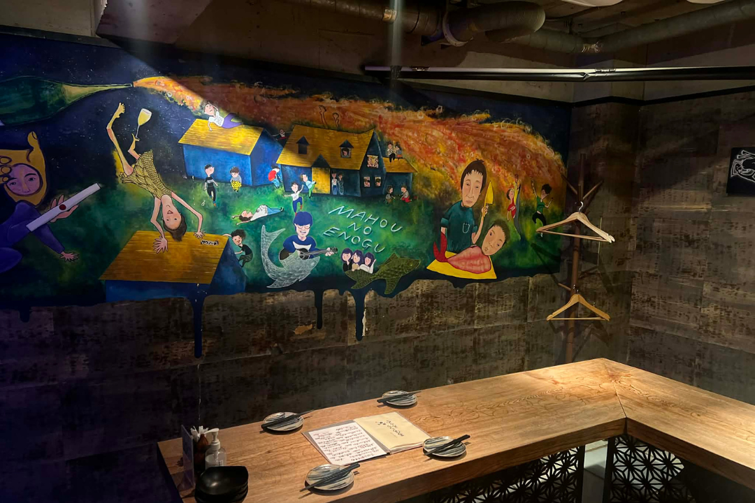Artistic mural on the wall at Mahou no Enogu