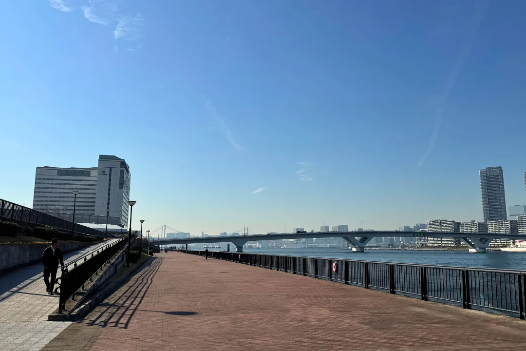 Wide waterfront promenade in Toyosu with skyline views