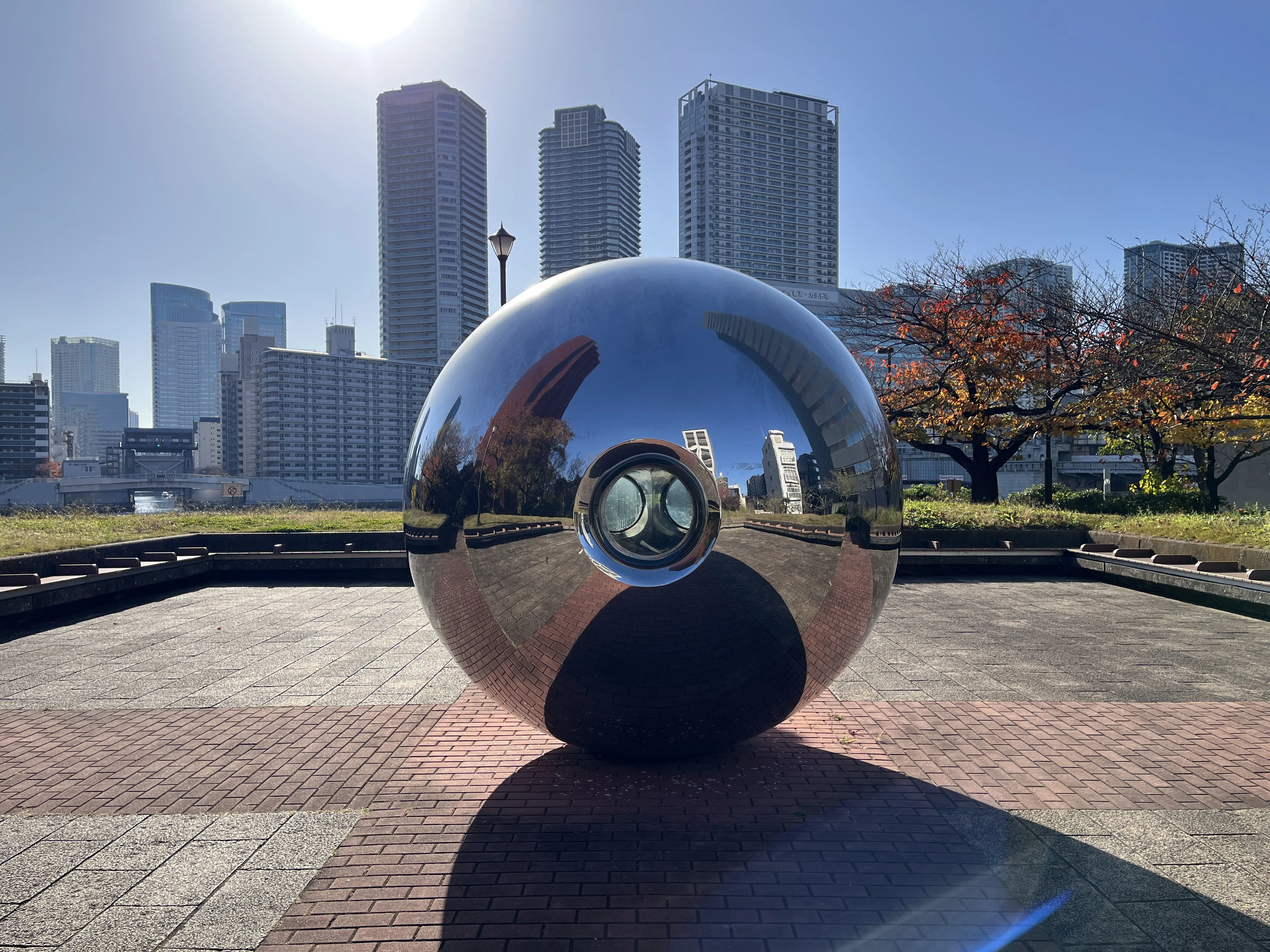 My Sky Hole sculpture reflecting the Tokyo skyline at Hatoba Park
